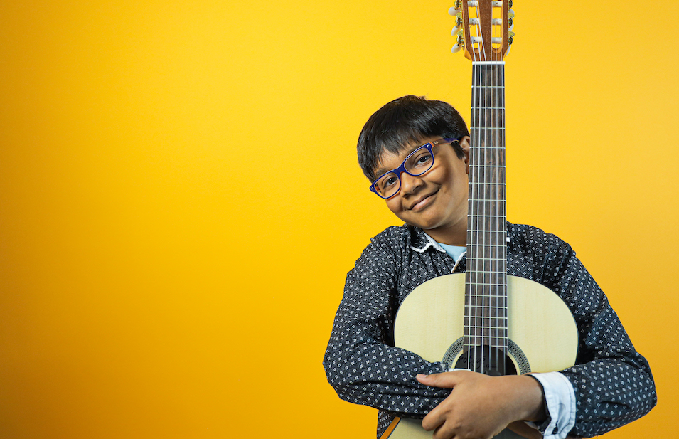 Guitar Student smiling at the camera during photo shoot at Minnesota School of Music in Blaine, MN