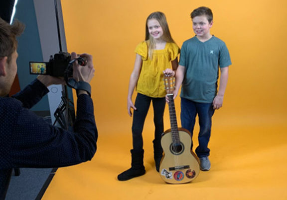 two students posing with guitars during photoshoot at Minnesota School of Music