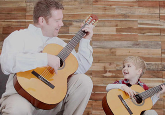 Eric Nehring and his son, Caleb Nehring playing guitar at Minnesota School of Music
